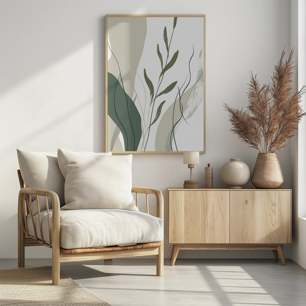 An abstract botanical art print in a black frame. The composition features stylized green leaves and stems layered over muted beige and sage green shapes against a clean white background. Wall Art
