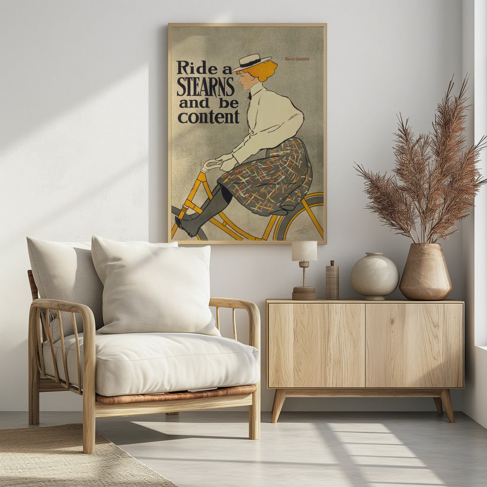 A vintage advertisement poster by Edward Penfield for Stearns bicycles. The poster features a woman with orange-blonde hair and a white hat riding a yellow bicycle. The text on the left says 'Ride a STEARNS and be content'. Decor