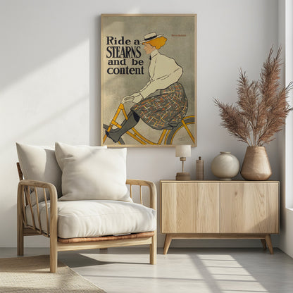 A vintage advertisement poster by Edward Penfield for Stearns bicycles. The poster features a woman with orange-blonde hair and a white hat riding a yellow bicycle. The text on the left says 'Ride a STEARNS and be content'. Decor