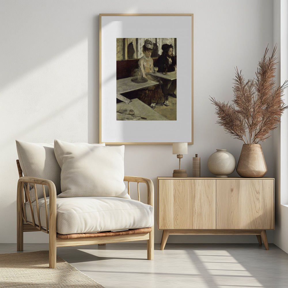A framed print of Edgar Degas's painting 'L'Absinthe,' depicting a somber-looking man and woman sitting at adjacent tables in a 19th-century Parisian cafe, conveying a sense of alienation and melancholy. Print