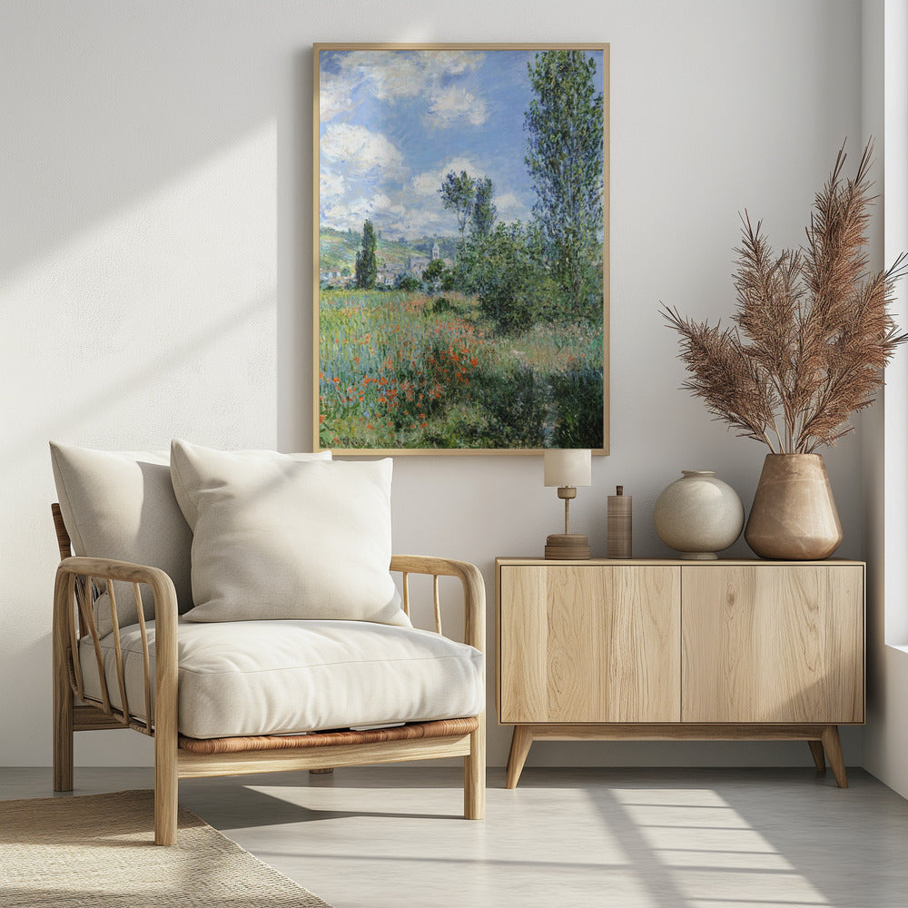 An impressionist painting depicting a vibrant green field filled with red poppies under a bright blue sky with fluffy white clouds. Tall green trees stand on the right, and in the distance, a small village with a church steeple is nestled in the rolling hills. Decor