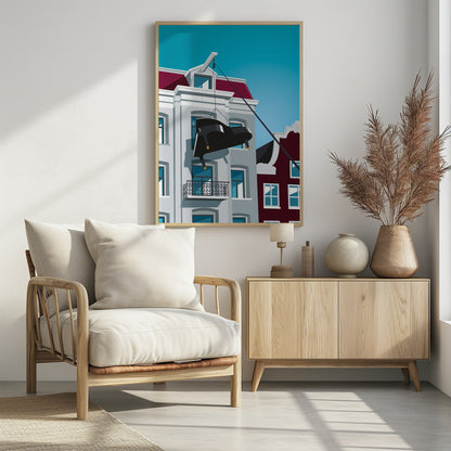 A graphic illustration of a black grand piano being hoisted up the side of a gray Amsterdam-style building with a red roof, using a pulley system attached to the gable. The scene is set against a clear, bright blue sky. Artwork