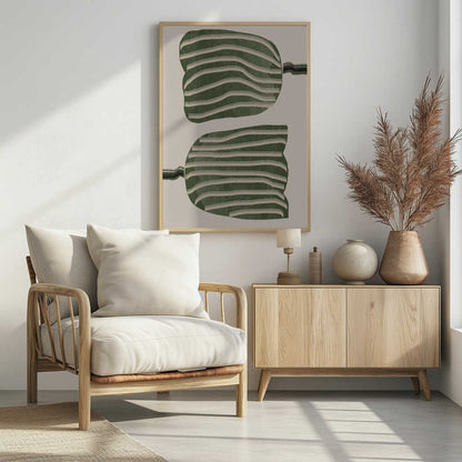 A framed abstract artwork featuring two large, organic, blob-like shapes stacked vertically. The shapes are dark green with wavy, horizontal cream-colored stripes. They are set against a solid cream background, with thin, distorted lines extending from the sides of each shape. Decor