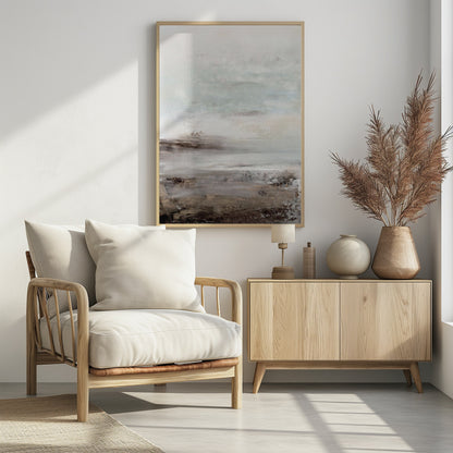 A vertical abstract painting in a thin black frame, featuring a muted and serene color palette. The composition resembles a misty landscape, with a light, off-white and pale blue-gray sky transitioning into a textured foreground of beige, brown, and taupe horizontal brushstrokes. Poster