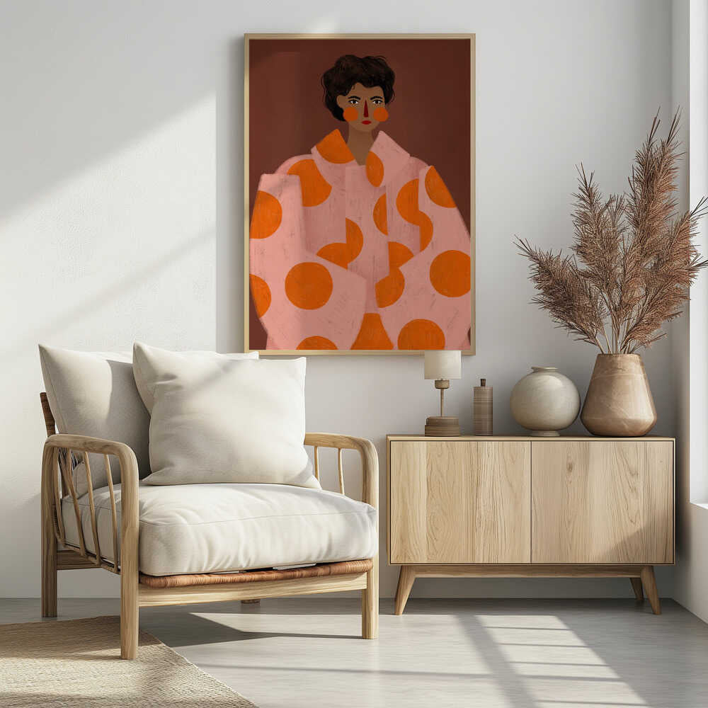 A stylized portrait illustration of a person with dark curly hair and warm brown skin against a solid reddish-brown background. They wear a light pink, oversized coat with large orange polka dots, and look directly forward with a neutral expression, accented by red lipstick and circular orange blush. Decor