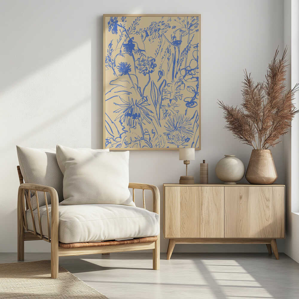 An expressive blue line drawing of various wildflowers and foliage on a beige background, enclosed in a simple black frame. The style is loose and sketchy, creating a dense and vibrant botanical composition. Decor