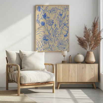 An expressive blue line drawing of various wildflowers and foliage on a beige background, enclosed in a simple black frame. The style is loose and sketchy, creating a dense and vibrant botanical composition. Decor