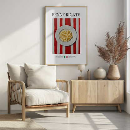 A framed art print featuring a painted illustration of a white plate of penne rigate pasta. The plate is centered on a background of bold red and white vertical stripes. At the top, the words 'PENNE RIGATE' are printed in a black serif font. At the bottom, the Italian words 'TRADIZIONE' and 'ARTIGIANALE' are shown with small green and red squares, evoking the Italian flag. Artwork