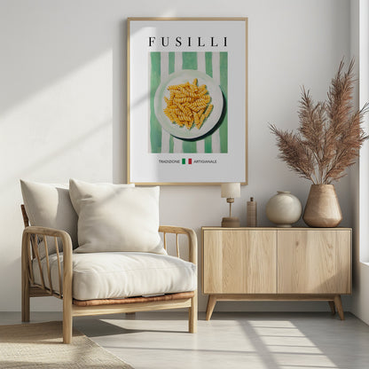 A vintage-style art print of a plate of fusilli pasta on a green and white striped background. The word 'FUSILLI' is printed at the top in black serif font. At the bottom, the words 'TRADIZIONE' and 'ARTIGIANALE' are separated by a small Italian flag icon. The poster is shown in a black frame. Wall Art