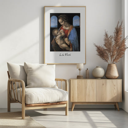 A framed art print of Leonardo da Vinci's painting 'Madonna Litta,' featuring the Virgin Mary in a red dress and blue cloak breastfeeding the infant Jesus. They are framed by two arched windows showing a distant landscape, all set within a black frame with white matting. Wall Art