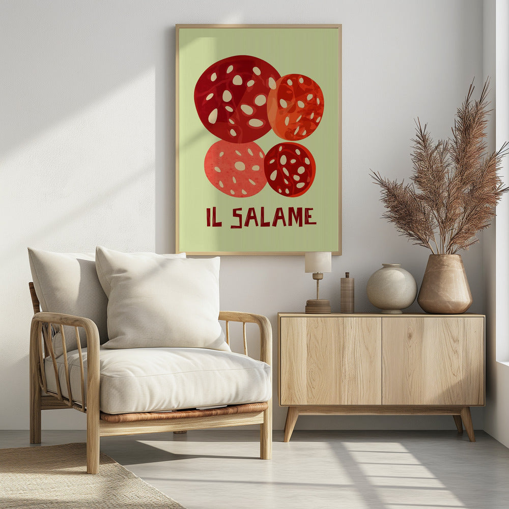 A vintage-style graphic art print of four overlapping slices of salami against a pale green background. The Italian words 'IL SALAME' are printed below in a dark, stylized font. The artwork is enclosed in a black frame. Poster