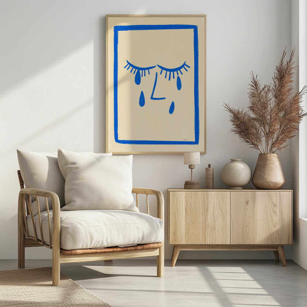 A minimalist framed illustration of a crying face. Bold blue lines on a cream background depict two closed eyes with long lashes, an L-shaped nose, and three large teardrops. The artwork is contained within a thick, hand-drawn blue border. Wall Art