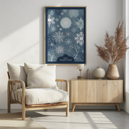 A vertical art print with a winter theme, featuring a variety of white and light blue snowflakes of different sizes and intricate designs scattered across a dusty blue background. At the bottom, silhouettes of bare white tree branches are visible, and a dark blue cloud-like shape holds the text 'Winter Wonder Land' in a white font. The artwork is framed in black. Artwork