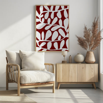 A framed abstract botanical artwork featuring a bold pattern of white, painterly vines and leaves set against a deep, textured crimson red background. Print