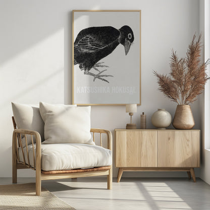 A black and white Japanese woodblock print by Katsushika Hokusai from 1814. The artwork features a stylized black crow with a textured, inky appearance, bending its head down against a light, grainy background. The piece is framed in black. Decor