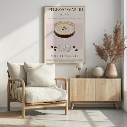 A vintage-style art print poster for an Espresso Martini. It features a detailed illustration of the cocktail in a ribbed coupe glass, garnished with three coffee beans on its foam. The background is beige and pink, with text that reads 'ESPRESSO MARTINI', 'EST. 1952', 'MADE IN ENGLAND', and a description of the drink. The poster has a thin black border. Decor