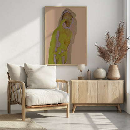 An abstract artwork of a hooded figure rendered in watercolor style against a flat peach background. The figure is primarily a vibrant yellow-green with brown and purple undertones, and its face is detailed with fine black line work. The piece is enclosed in a simple black frame. Decor