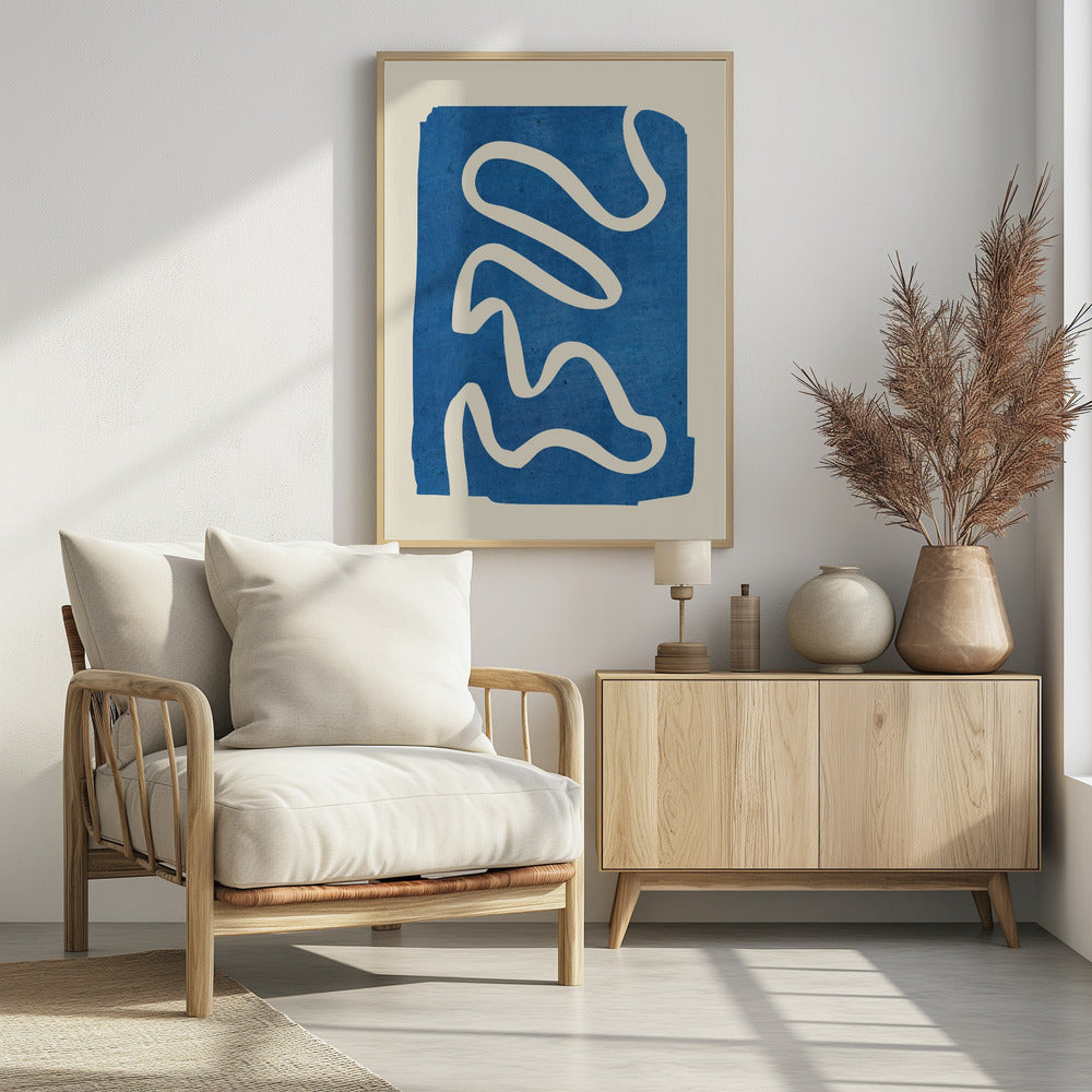 An abstract art piece in a black frame, featuring a solid, textured blue shape on a cream background. A single, thick, meandering white line flows from the top to the bottom within the blue area, creating a simple yet dynamic composition. Decor