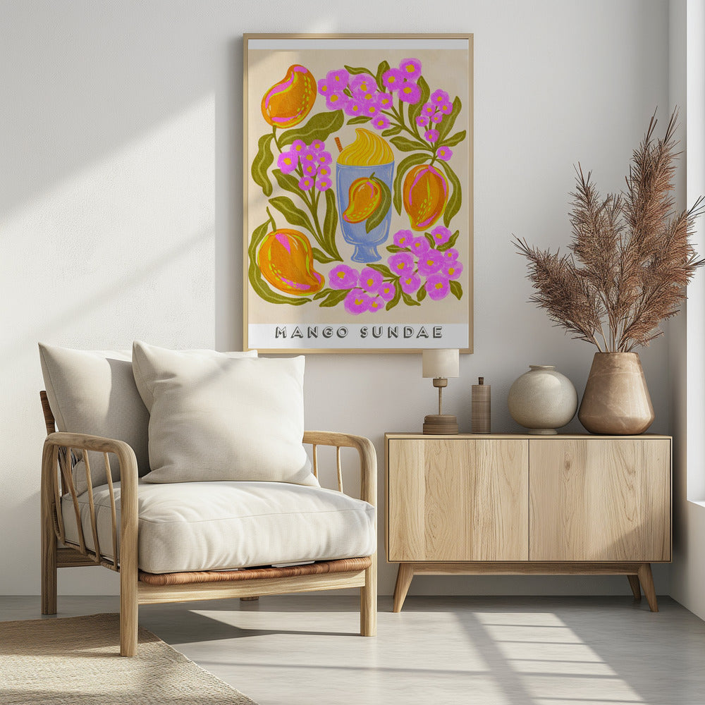 A colorful, stylized art print featuring a central blue glass filled with a yellow mango sundae. The glass is surrounded by lush orange mangoes, vibrant pink flowers with yellow centers, and dark green leaves on a cream-colored background. At the bottom, the words 'MANGO SUNDAE' are written in a bold, block font. Poster