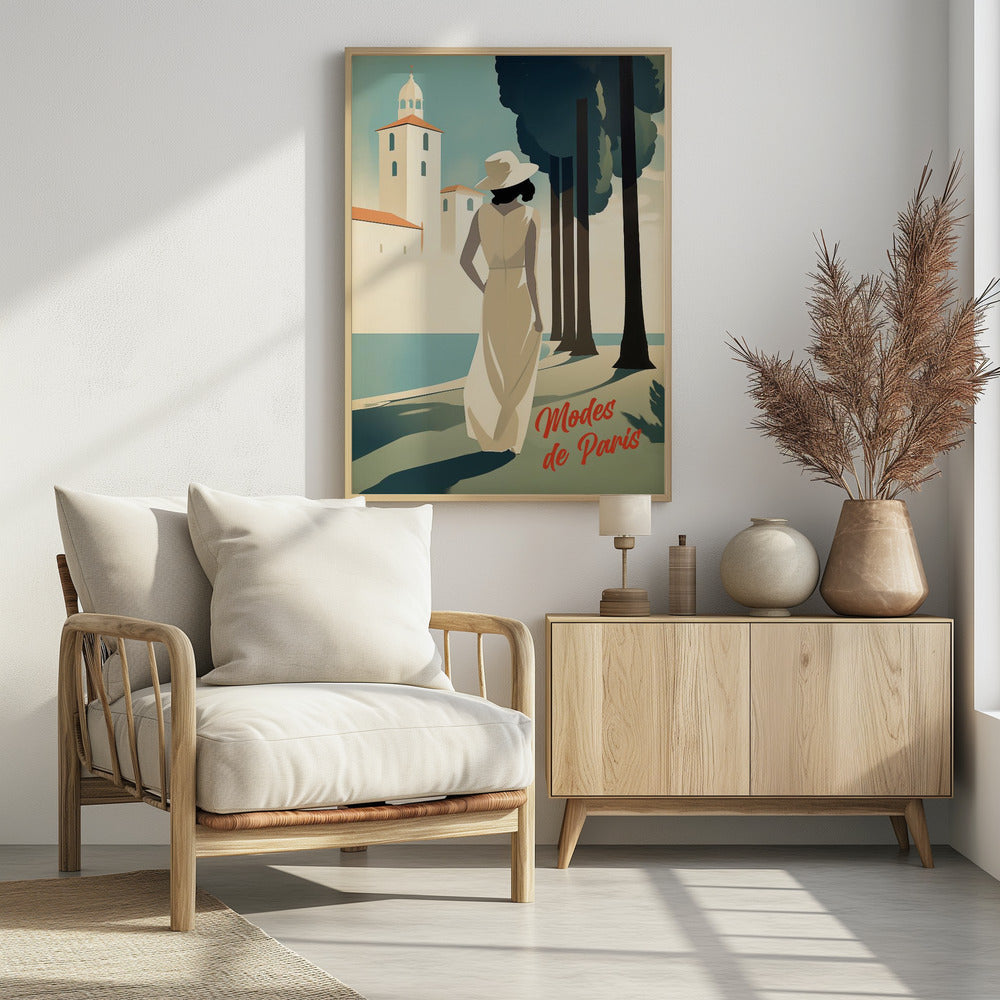 An Art Deco style illustration of a woman in a long cream dress and a white hat, viewed from behind. She stands by a body of water with tall, dark trees to her right and a white coastal building in the background. Red cursive text in the corner reads 'Modes de Paris'. Wall Art