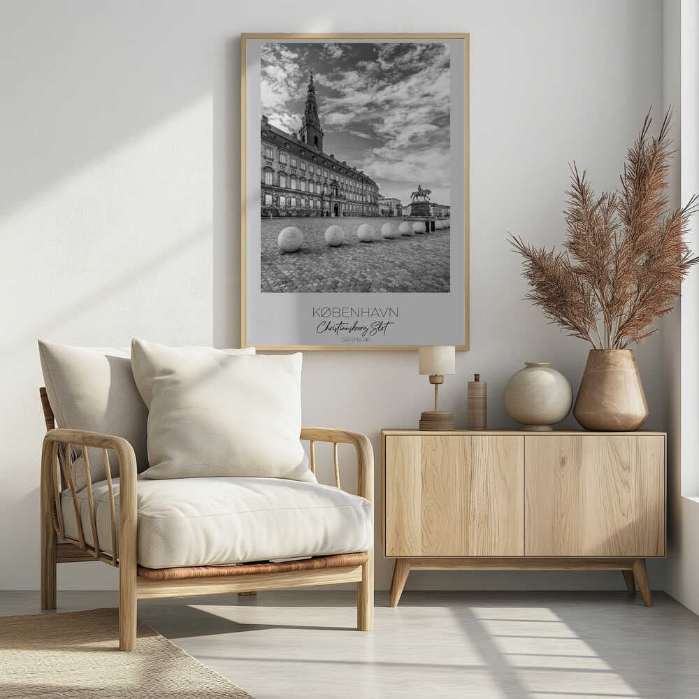 A black and white travel poster of Christiansborg Palace in Copenhagen, Denmark. The image shows the grand building and its tower against a dramatic cloudy sky, with a cobblestone square, stone bollards, and an equestrian statue in the foreground. Text at the bottom identifies the location. Decor