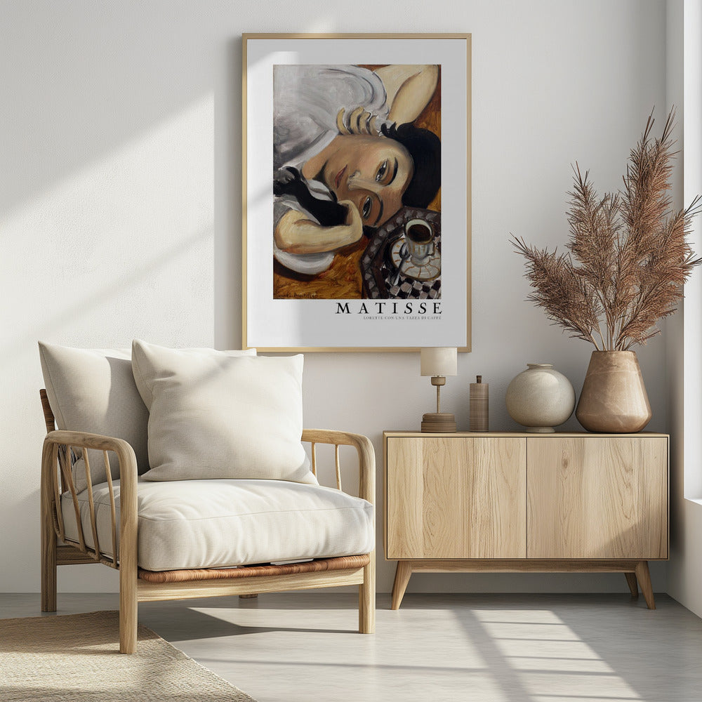 A framed art print of Henri Matisse's painting, 'Lorette con una tazza di caffè' (Lorette with a Cup of Coffee). The portrait features a woman with dark hair lying down, gazing directly at the viewer, with a cup of coffee on a checkered saucer beside her. The artist's name and the title are printed below the image. Decor