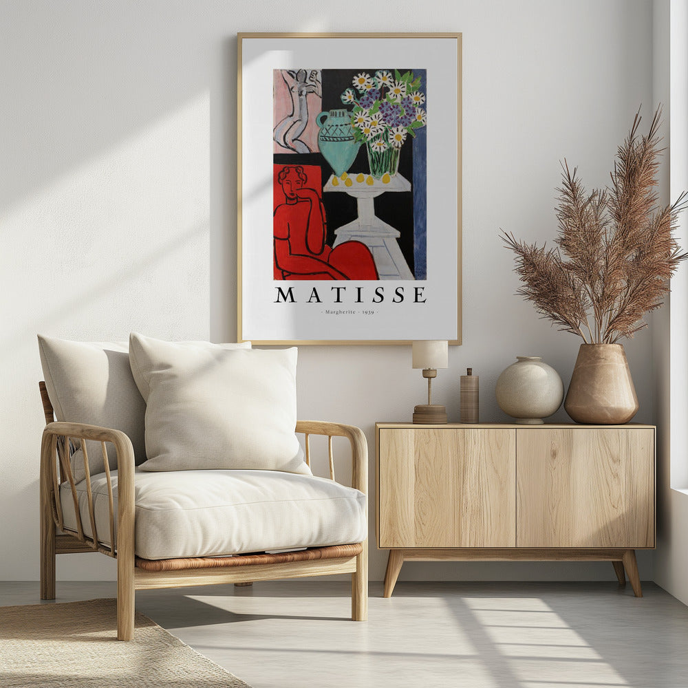 A framed art poster of Henri Matisse's painting 'Margherite' from 1939. The vibrant Fauvist artwork depicts a woman in a bold red dress, a still life with a turquoise vase of daisies on a white table, and a small sketch of a nude in the background. The artist's name is printed below the image. Poster