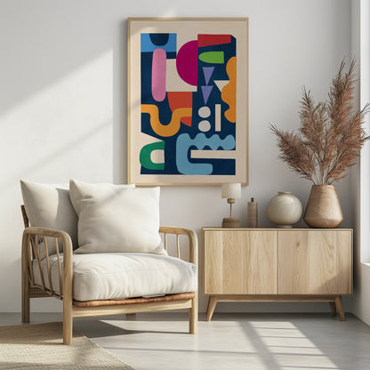 A modern abstract art print in a black frame, featuring a vibrant collage of colorful, cut-out style shapes against a dark navy blue background. The composition includes a mix of geometric and organic forms in shades of magenta, pink, orange, green, red, purple, and light blue, all contained within a cream-colored border. Print