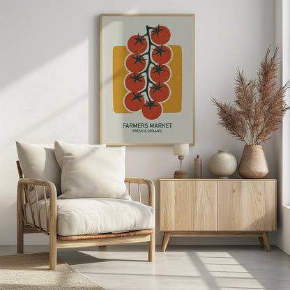 A vintage-style art print of bright red cherry tomatoes on a dark green vine, set against a mustard yellow rectangle on an off-white background. Below the image, text reads 'FARMERS MARKET' and 'FRESH & ORGANIC'. Decor