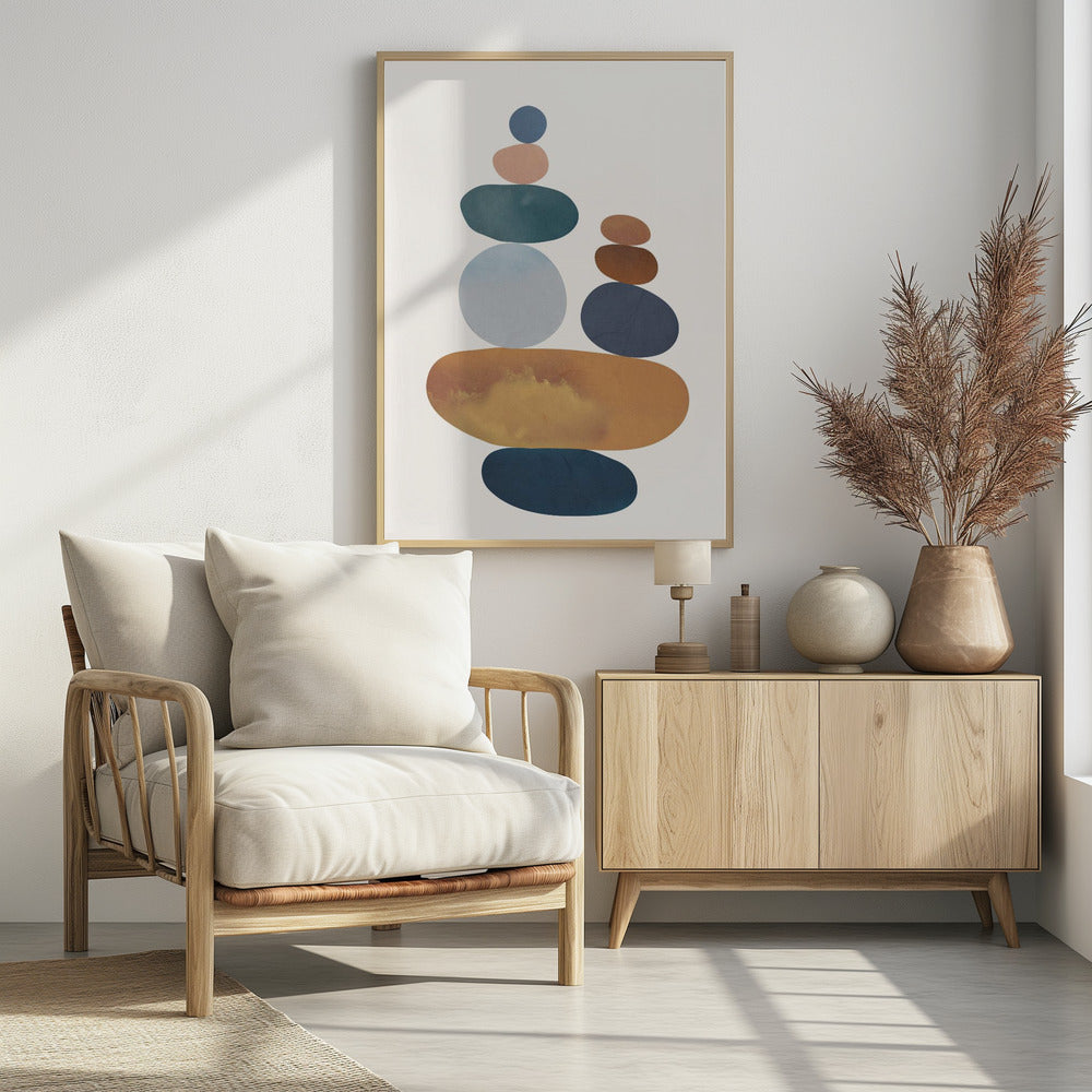 A minimalist abstract painting of two stacks of colorful, smooth stones balanced on top of each other. The color palette includes shades of blue, orange, brown, and pink against a light-colored background, enclosed in a black frame. Print