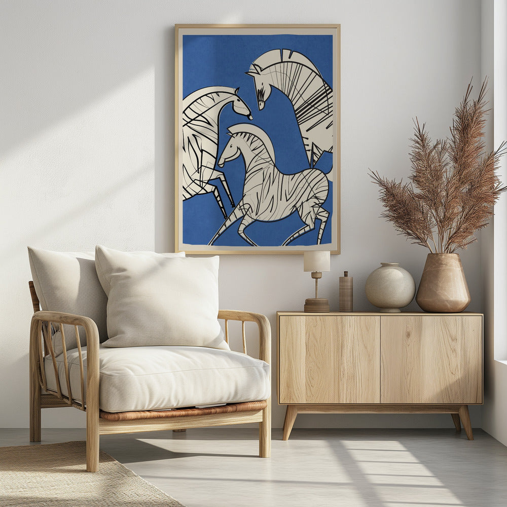 A modern, graphic illustration of three stylized zebras against a bold blue background. The zebras are off-white with thick black outlines and stripes, creating a dynamic and abstract composition. The artwork is presented within a simple black frame. Decor