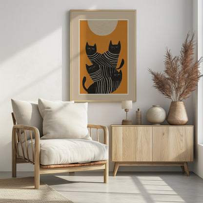 A framed art print of a stylized illustration featuring four black cats with white striped bodies stacked together. They are set against a solid orange background with a large, textured, cream-colored moon or sun at the top. Artwork
