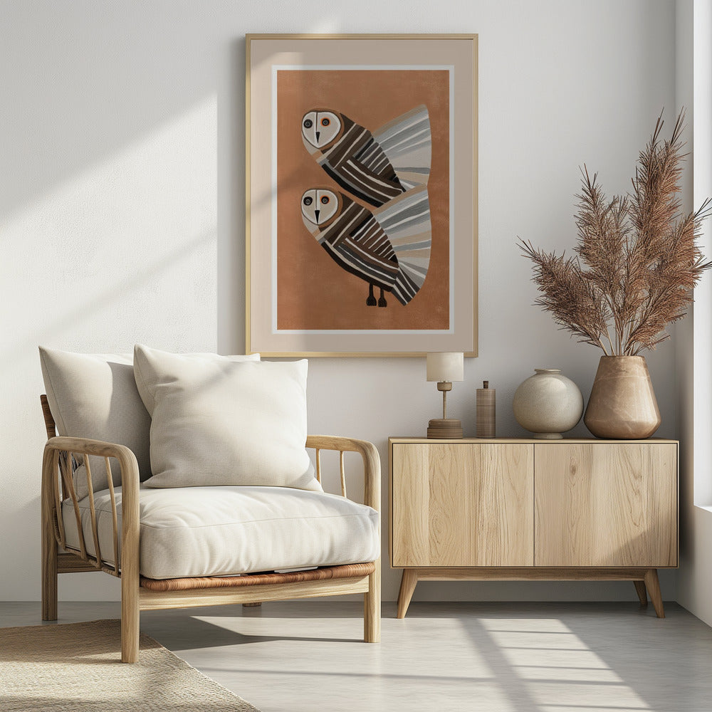 A framed modern art print of two stylized barn owls against a warm brown background. The owls are decorated with geometric stripes in shades of brown, beige, grey, and black, and have large, captivating eyes. Wall Art