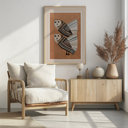 A framed modern art print of two stylized barn owls against a warm brown background. The owls are decorated with geometric stripes in shades of brown, beige, grey, and black, and have large, captivating eyes. Wall Art