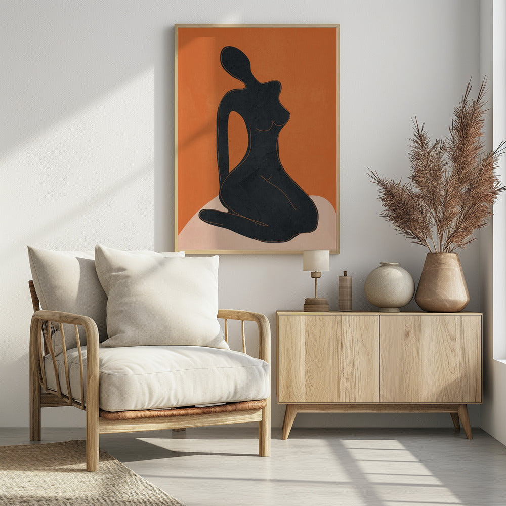 A minimalist abstract art piece featuring a solid black silhouette of a seated female figure against a textured, bold orange background. The figure is posed gracefully, sitting on a light beige, curved surface. The entire piece is enclosed in a simple black frame. Print