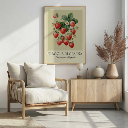 A vintage-style botanical poster featuring a detailed illustration of a strawberry plant with bright red berries, green leaves, and a small white flower. The background is a soft, pale yellow. Below the illustration, the text reads 'FRAGOLA DI CESENA' and 'Coltivazioni Pregiate' in Italian. The entire print is framed in black. Print
