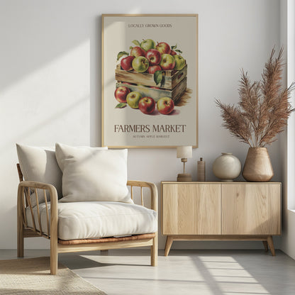 A vintage-style art print advertising a farmers market. It features an illustration of red and green apples in wooden crates against a cream background. The text reads 'Locally Grown Goods' and 'Farmers Market, Autumn Apple Harvest'. Print