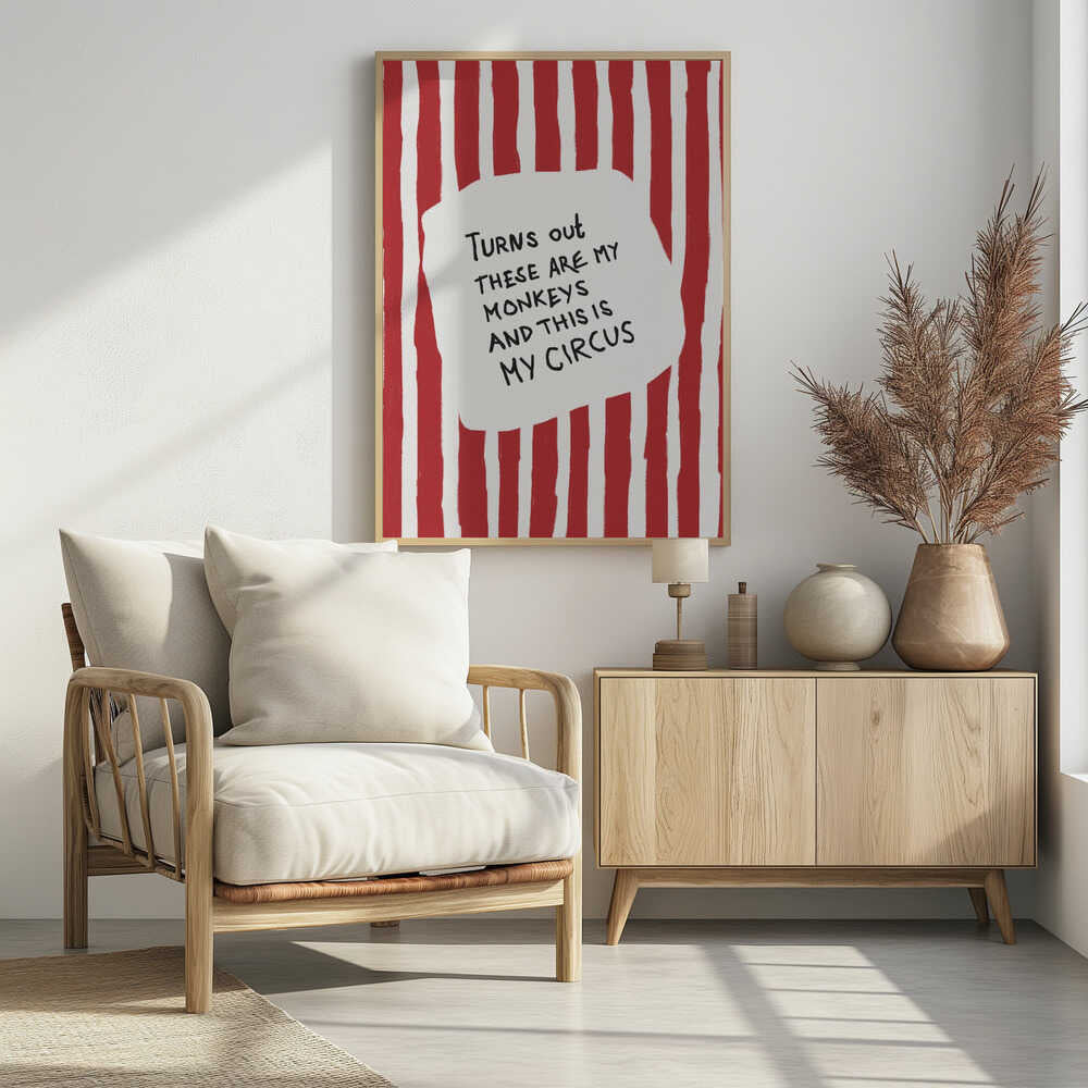 A framed art print featuring the humorous quote 'Turns out these are my monkeys and this is my circus' in black handwritten text. The text is centered on a white, cloud-like shape against a background of bold, hand-painted red and white vertical stripes, reminiscent of a circus tent. Poster