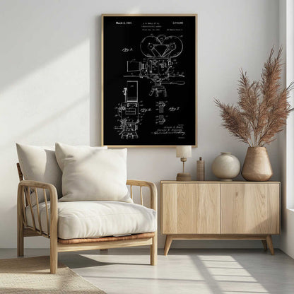 A framed vintage patent illustration for a cinematographic camera, presented as a white line drawing on a black background. The blueprint-style artwork shows detailed diagrams of a 1930s movie camera, complete with text from the original patent filing. Artwork