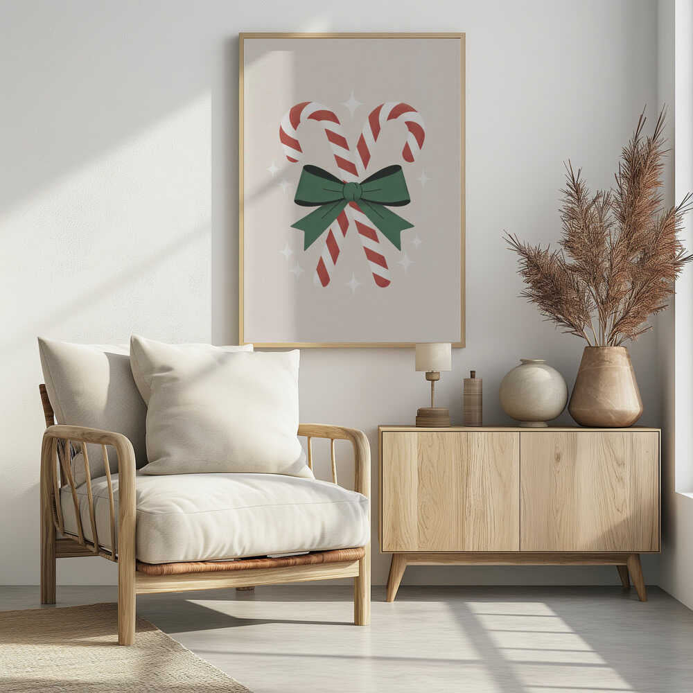 An illustration of two red-and-white striped candy canes crossed and tied together with a large green bow. The background is a soft beige color with small, white, four-pointed star sparkles. The artwork is shown in a black frame. Decor