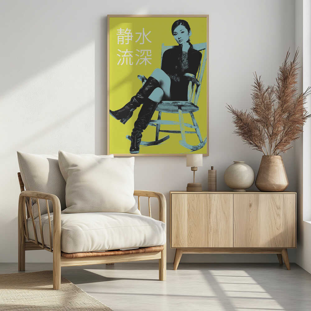 A pop art style poster with a stark yellow background featuring a woman in a black jacket and tall black boots sitting in a rocking chair. The image is rendered in high contrast with black and light blue tones. The woman is looking at the viewer with her chin on her hand. To the left, there are four large white Japanese characters. The entire piece is framed in black. Print