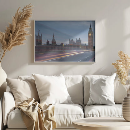 A framed, long-exposure photograph of London's Big Ben and the Houses of Parliament at dusk. In the foreground, streaks of red and yellow light from moving traffic blur across a bridge, creating a dynamic contrast with the historic architecture against a twilight sky. Decor