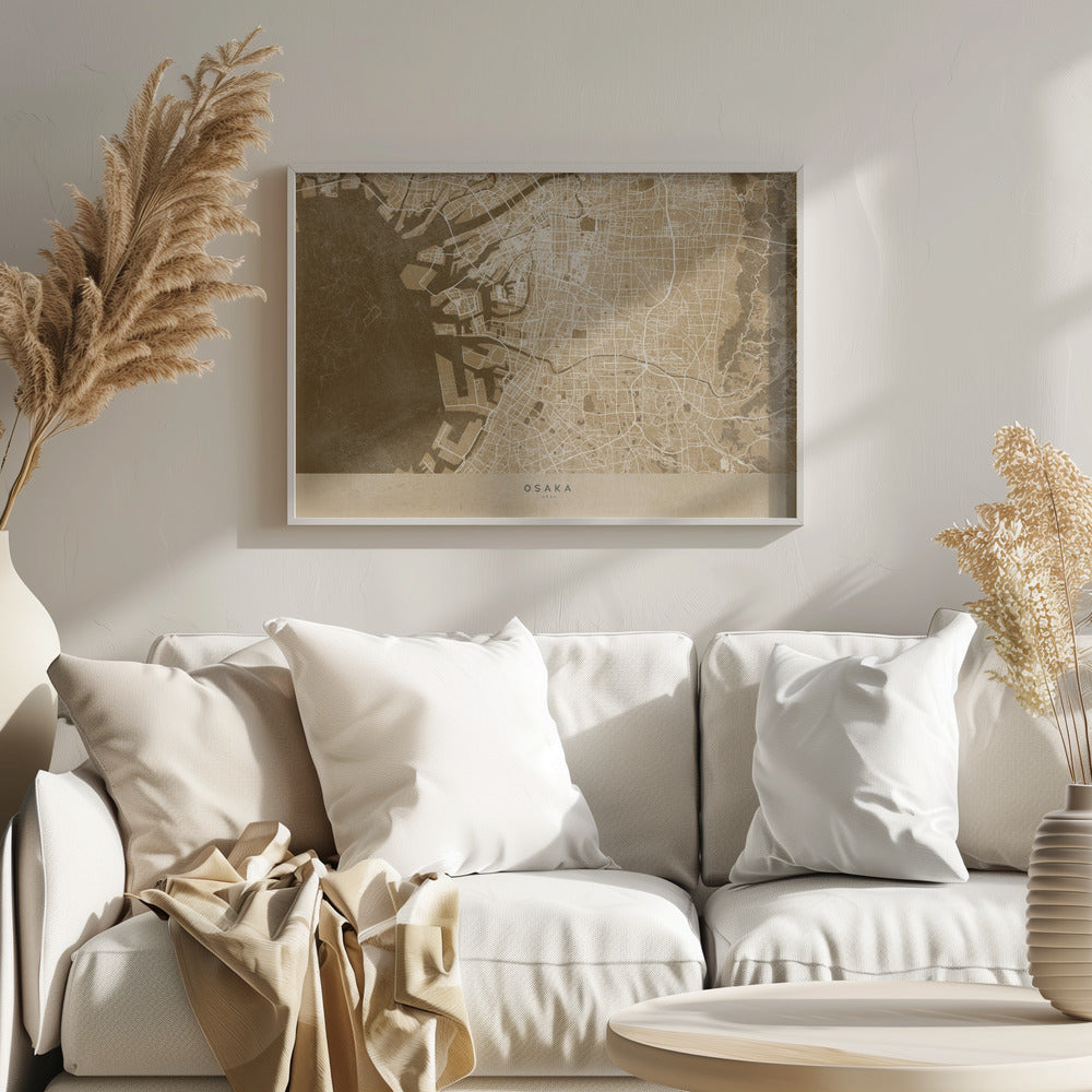 A framed, stylized map of Osaka, Japan, presented in monochrome brown and beige tones. The city's streets and coastline are intricately detailed in thin white lines against a textured brown background for the water and a lighter beige for the land, all enclosed within a sleek silver frame. Poster