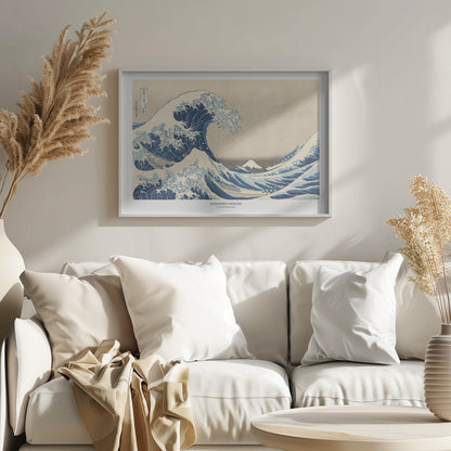 A framed print of Katsushika Hokusai's famous woodblock artwork, 'The Great Wave off Kanagawa,' featuring a giant, turbulent blue wave with white foam cresting over small boats, with Mount Fuji visible in the background under a muted sky. Wall Art