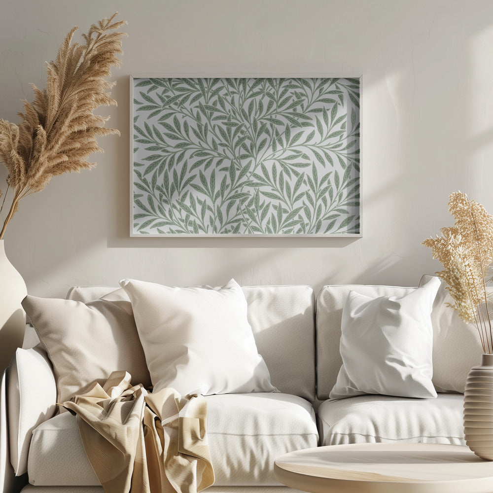 A framed art print with a repeating pattern of sage green leaves and branches on a white background. The style is elegant and inspired by nature, and the print is housed in a simple silver frame. Poster