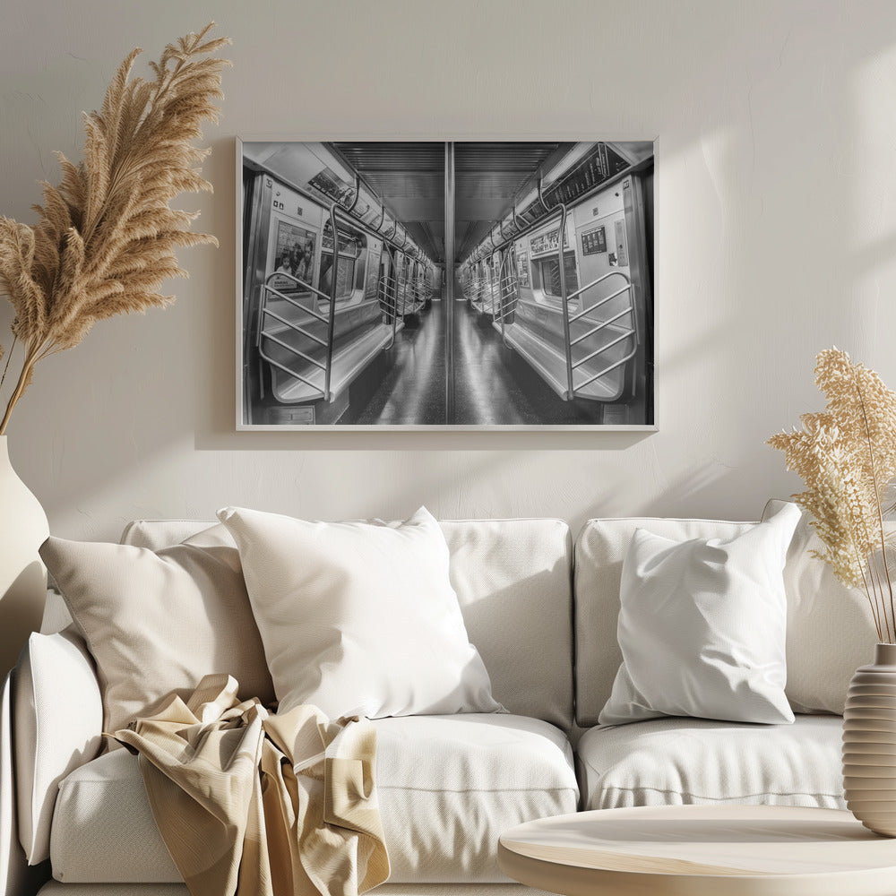 A framed, black and white photograph capturing a perfectly symmetrical view down the aisle of an empty subway car. The reflective, dark floor and the metallic seats and handrails create strong leading lines, giving the image a sense of depth and urban solitude. Wall Art