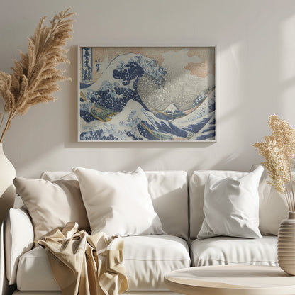 A framed reproduction of Hokusai's 'The Great Wave off Kanagawa,' depicting a massive, curling blue wave with white foam cresting over fishing boats. In the background, a small, snow-capped Mount Fuji stands under a pale orange and grey sky. Poster