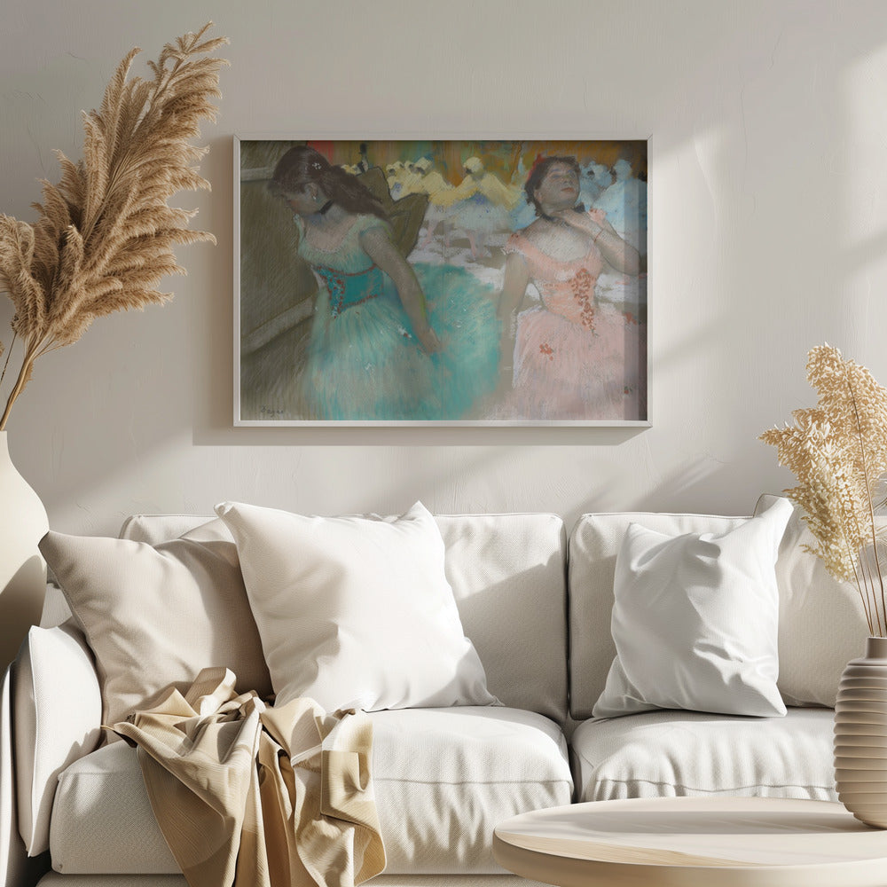 A framed pastel artwork by Edgar Degas depicting several ballerinas. In the foreground, a ballerina in a turquoise tutu looks down, while another in a pink tutu adjusts her collar with her eyes closed. In the background, more dancers in yellow and white are blurred on a stage. Wall Art