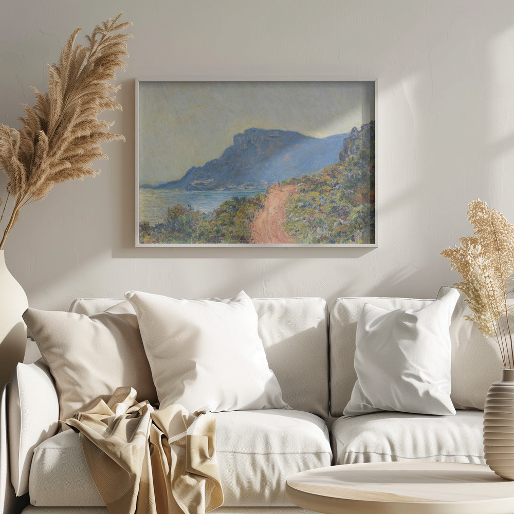 An Impressionist painting by Claude Monet titled 'Cap Martin, near Menton', depicting a sunlit coastal scene. A reddish-brown path winds along a vibrant, brush-covered cliff in the foreground, overlooking the blue Mediterranean Sea. A large, hazy blue mountain dominates the background under a pale yellow sky. Decor