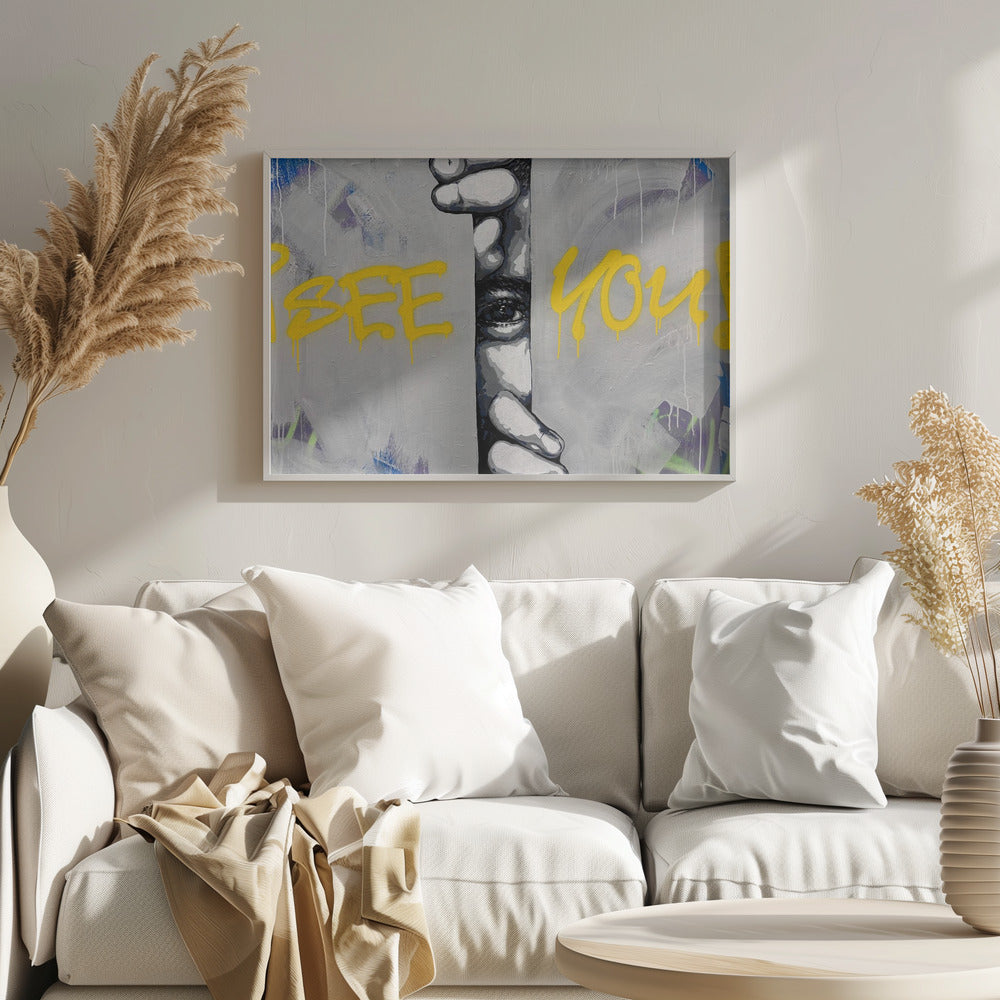 A framed modern art piece depicting a black and white eye peeking through a narrow vertical opening, with hands gripping the sides. The background is a textured gray with vibrant yellow graffiti-style text that reads 'I SEE YOU!' with paint drips. Print